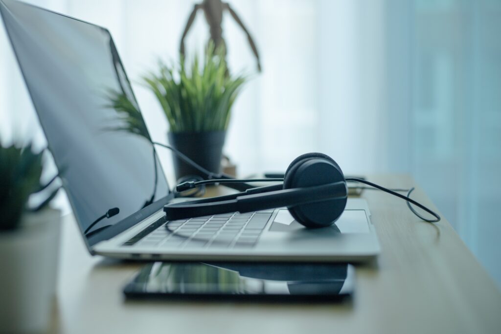 headset headphones telephone and laptop in home office call center